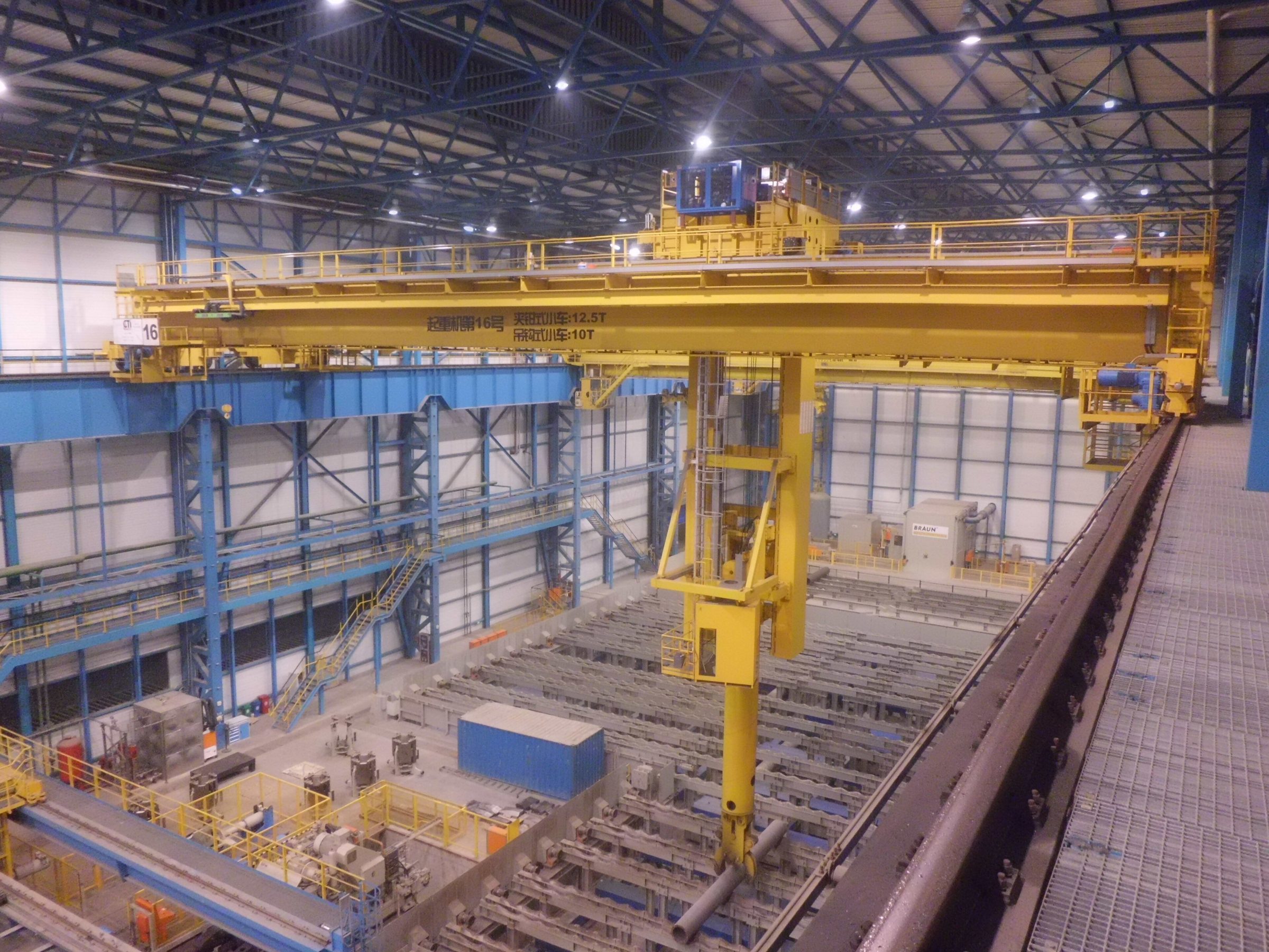 Overhead crane running on crane runway beams inside a steel-framed industrial building