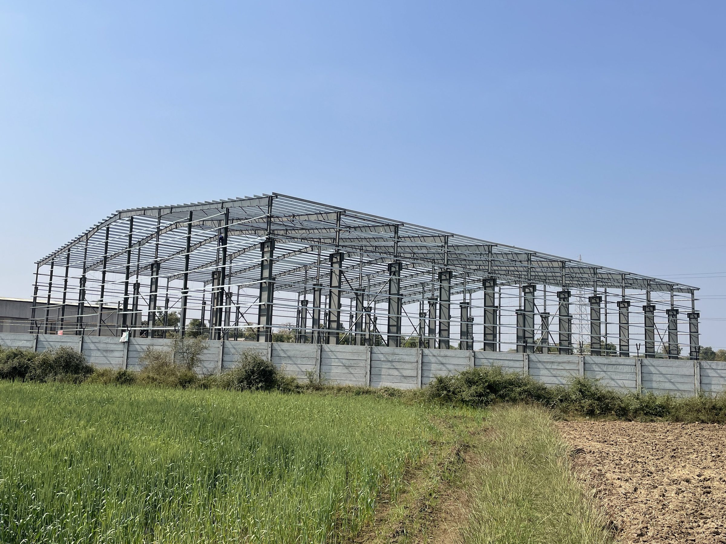 Erected PEB steel frame checked for alignment and finish by AcuFabInfraStructure